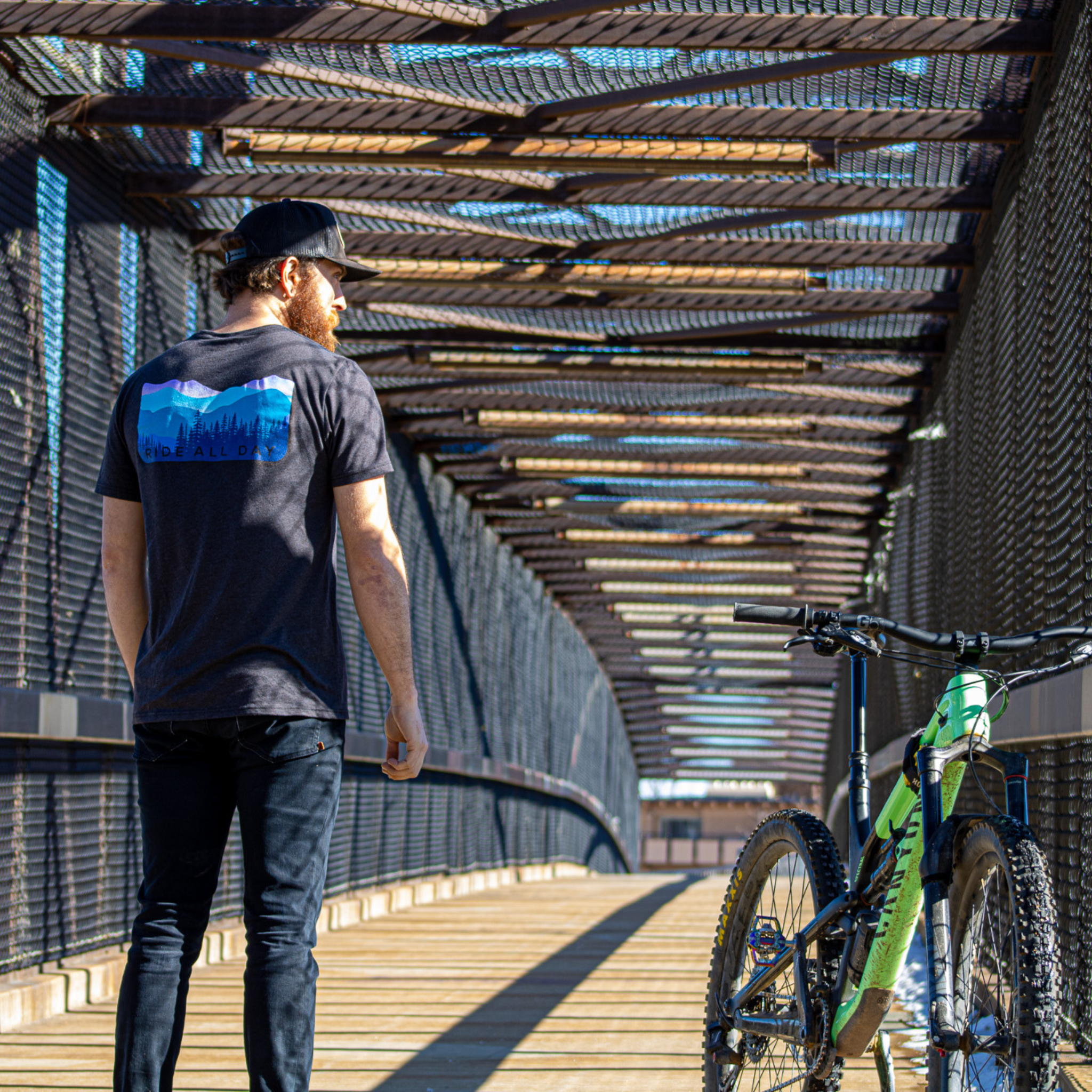 Model wearing the Dawn Patrol T-Shirt overlooking a city
