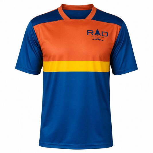 A short-sleeve athletic jersey with a color-blocked design featuring royal blue, orange, and yellow horizontal sections, with a 'RAD' logo on the left chest, shown on a plain white background.