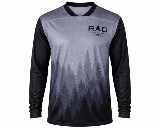 A long-sleeve cycling jersey with a gray and black forest tree gradient print, featuring a black collar and the 'Ride All Day' logo on the left chest, displayed on a solid gray background.