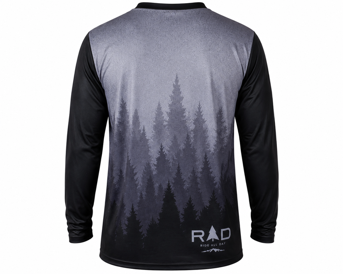 A long-sleeve performance cycling jersey shown from the back, featuring a black and gray gradient pine forest graphic with the brand logo 'RAD' printed near the lower back.